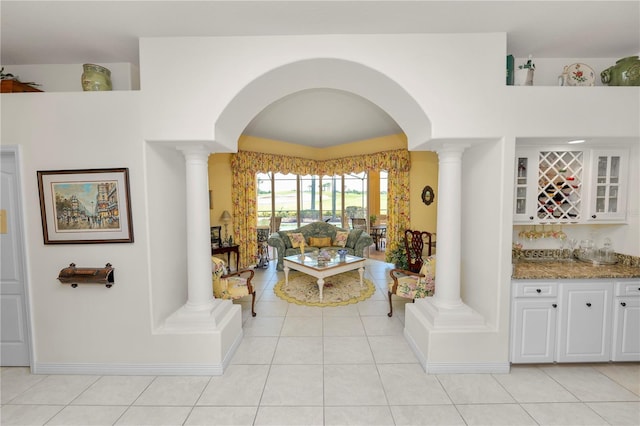 2936 Grasslands Dr, Lakeland, FL 33803 - living area with decorative columns, arched walkways, and bar
