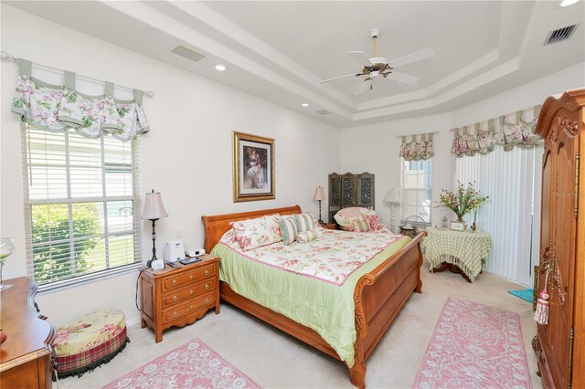 2936 Grasslands Dr, Lakeland, FL 33803 - bedroom with light carpet, a tray ceiling, a ceiling fan, and recessed lighting