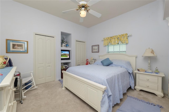 2936 Grasslands Dr, Lakeland, FL 33803 - bedroom featuring light colored carpet, two closets, and ceiling fan