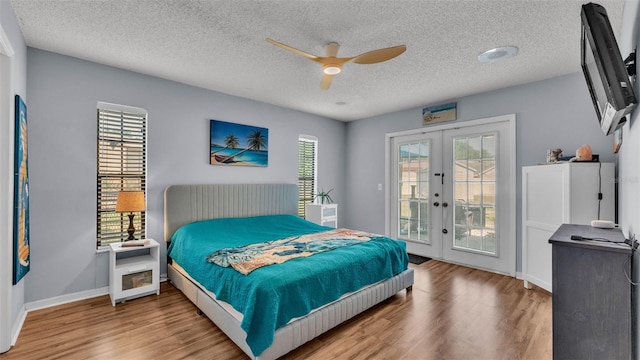 1423 Ridgegreen Loop N, Lakeland, FL 33809 - bedroom with french doors, access to outside, wood finished floors, multiple windows, and a textured ceiling