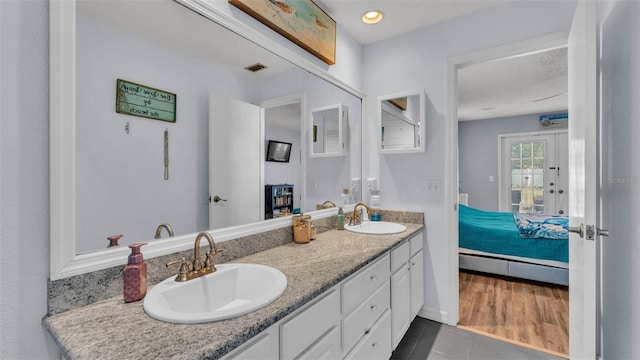1423 Ridgegreen Loop N, Lakeland, FL 33809 - ensuite bathroom featuring double vanity and tile patterned flooring
