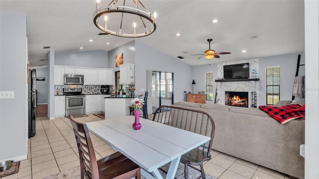1423 Ridgegreen Loop N, Lakeland, FL 33809 - dining room featuring light tile patterned floors, vaulted ceiling, a ceiling fan, a high end fireplace, and a chandelier