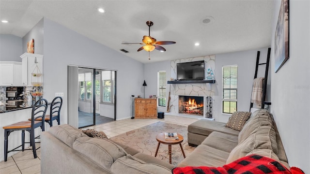 1423 Ridgegreen Loop N, Lakeland, FL 33809 - living room featuring light tile patterned floors, a fireplace, ceiling fan, healthy amount of natural light, and vaulted ceiling