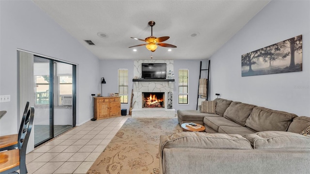 1423 Ridgegreen Loop N, Lakeland, FL 33809 - living room with ceiling fan, a large fireplace, light tile patterned floors, vaulted ceiling, and a textured ceiling