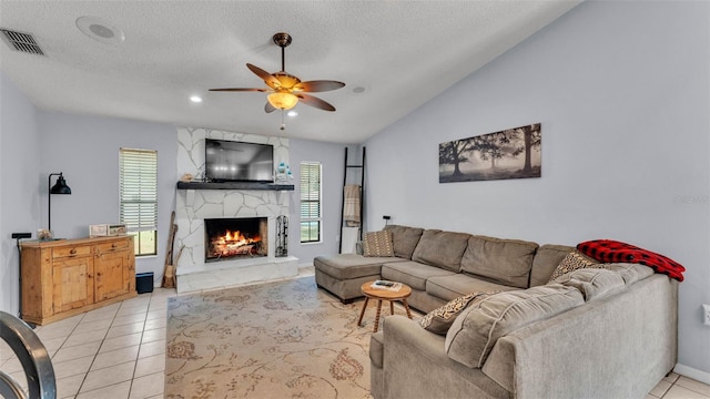 1423 Ridgegreen Loop N, Lakeland, FL 33809 - living room with ceiling fan, a fireplace, light tile patterned floors, a textured ceiling, and vaulted ceiling