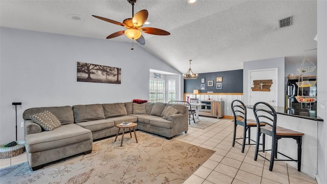 1423 Ridgegreen Loop N, Lakeland, FL 33809 - living area with vaulted ceiling, a textured ceiling, ceiling fan, a wainscoted wall, and light tile patterned floors
