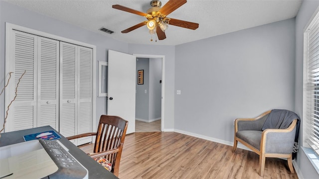 1423 Ridgegreen Loop N, Lakeland, FL 33809 - home office with ceiling fan, light wood-style floors, baseboards, and a textured ceiling