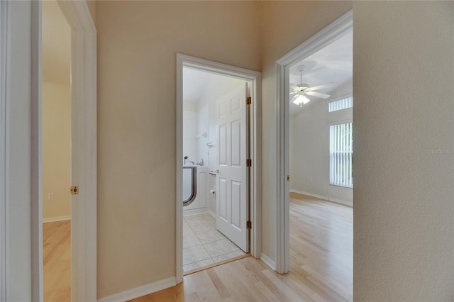 1003 Clearpointe Way, Lakeland, FL 33813 - hallway with light wood-style floors and baseboards