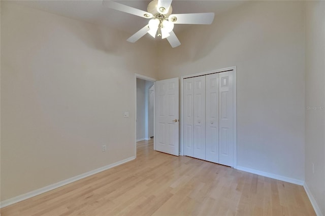 1003 Clearpointe Way, Lakeland, FL 33813 - unfurnished bedroom featuring light wood finished floors, baseboards, a closet, ceiling fan, and a high ceiling