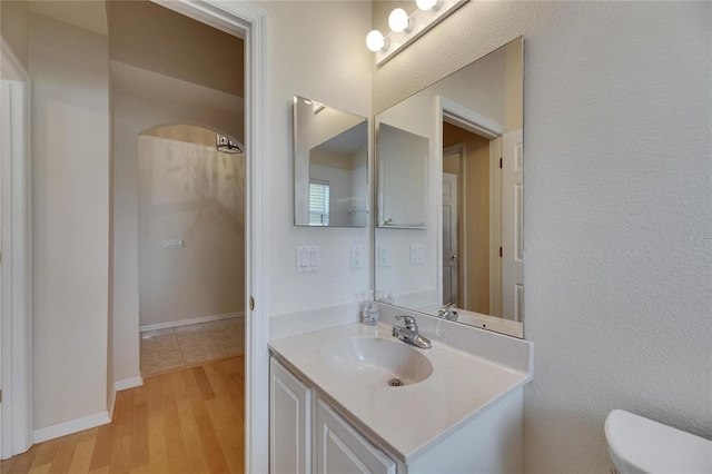 1003 Clearpointe Way, Lakeland, FL 33813 - bathroom featuring vanity, toilet, and wood finished floors