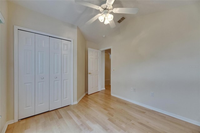 1003 Clearpointe Way, Lakeland, FL 33813 - unfurnished bedroom with light wood-style flooring, baseboards, vaulted ceiling, a closet, and ceiling fan