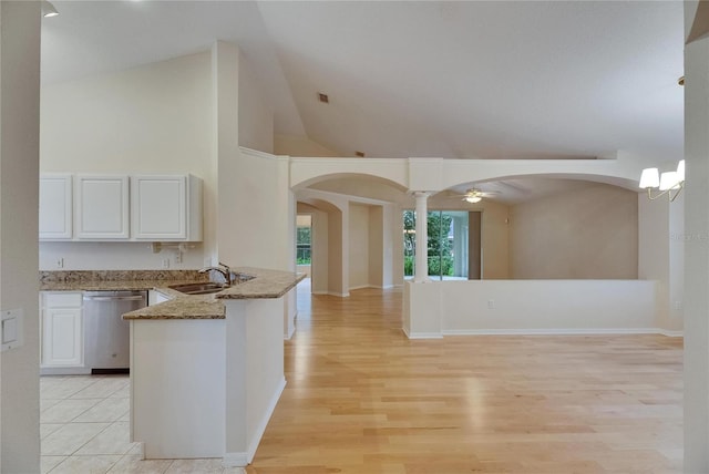 1003 Clearpointe Way, Lakeland, FL 33813 - kitchen with stainless steel dishwasher, stone countertops, white cabinets, arched walkways, and high vaulted ceiling