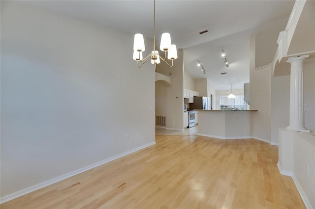 1003 Clearpointe Way, Lakeland, FL 33813 - unfurnished living room with a chandelier, light wood-style flooring, high vaulted ceiling, and baseboards