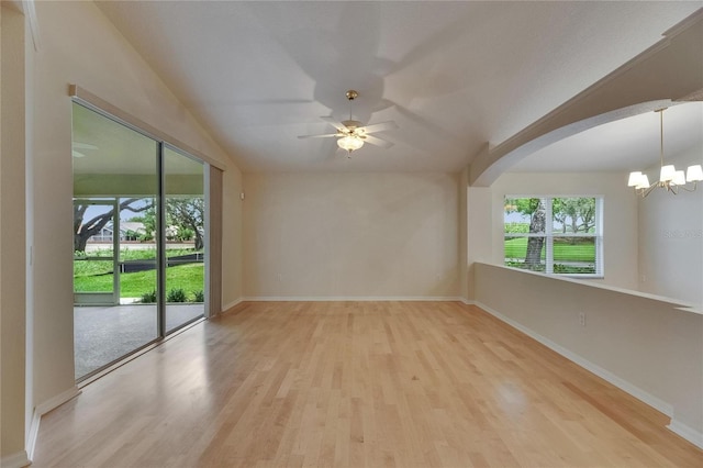 1003 Clearpointe Way, Lakeland, FL 33813 - empty room featuring a chandelier, wood finished floors, baseboards, ceiling fan, and lofted ceiling