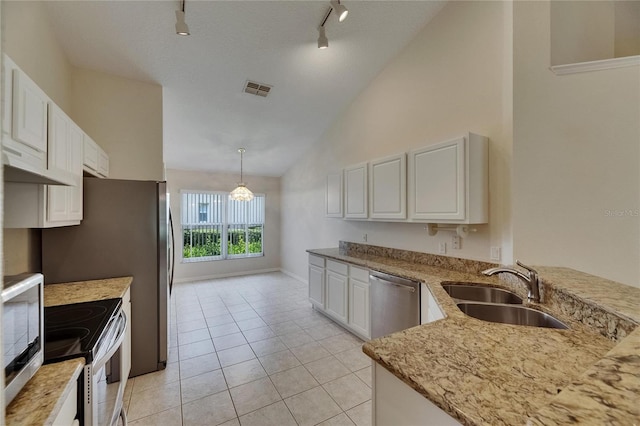 1003 Clearpointe Way, Lakeland, FL 33813 - kitchen featuring stainless steel appliances, a sink, track lighting, white cabinets, and light stone countertops