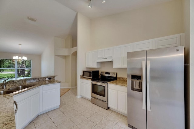 1003 Clearpointe Way, Lakeland, FL 33813 - kitchen with appliances with stainless steel finishes, a sink, under cabinet range hood, light stone counters, and light tile patterned flooring