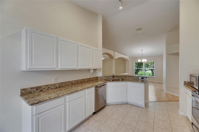 1003 Clearpointe Way, Lakeland, FL 33813 - kitchen featuring appliances with stainless steel finishes, a chandelier, a sink, white cabinetry, and a peninsula