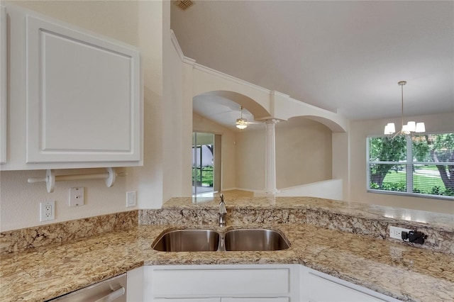 1003 Clearpointe Way, Lakeland, FL 33813 - kitchen featuring a sink, arched walkways, healthy amount of natural light, and white cabinets