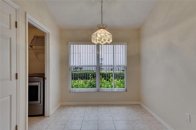 1003 Clearpointe Way, Lakeland, FL 33813 - unfurnished dining area with washer / dryer, a chandelier, baseboards, and light tile patterned flooring