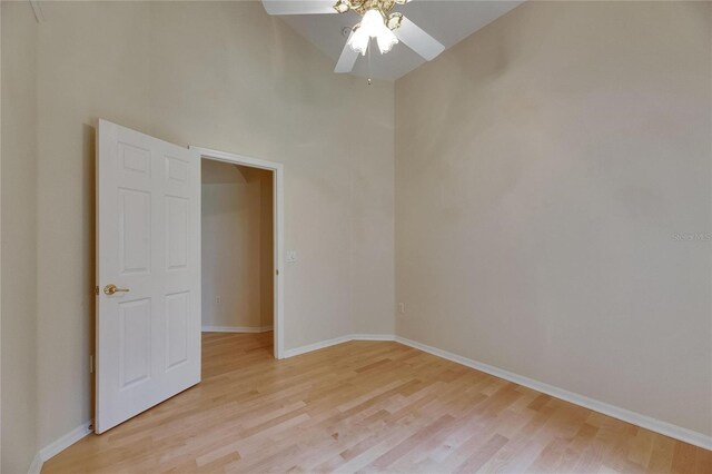 1003 Clearpointe Way, Lakeland, FL 33813 - empty room with a ceiling fan, light wood finished floors, baseboards, and a high ceiling