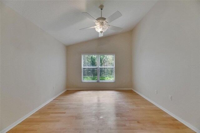 1003 Clearpointe Way, Lakeland, FL 33813 - spare room with light wood-style flooring, ceiling fan, vaulted ceiling, and baseboards