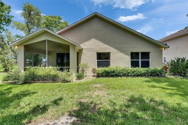 1003 Clearpointe Way, Lakeland, FL 33813 - back of property with stucco siding, ceiling fan, a yard, and a sunroom