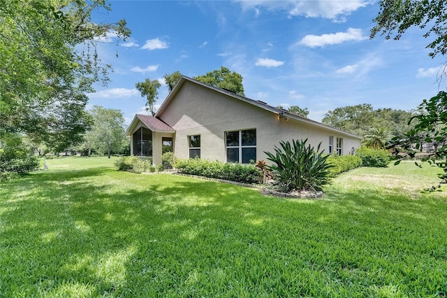 1003 Clearpointe Way, Lakeland, FL 33813 - view of property exterior with stucco siding and a lawn