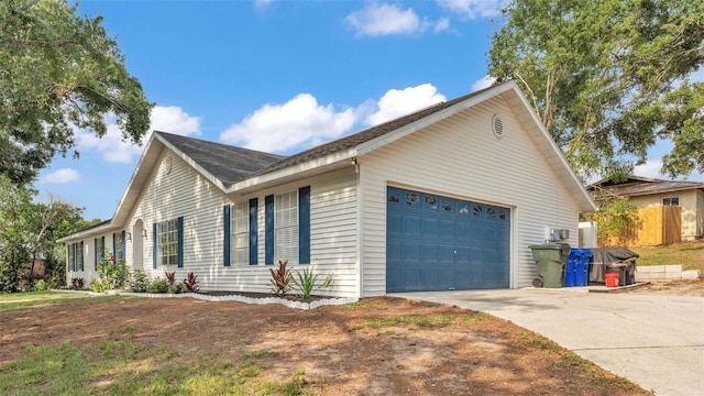 4825 Foxrun, Lakeland, FL 33813 - view of side of property featuring a garage and concrete driveway