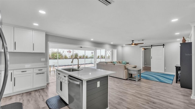 4825 Foxrun, Lakeland, FL 33813 - kitchen with appliances with stainless steel finishes, a sink, a barn door, light countertops, and white cabinets