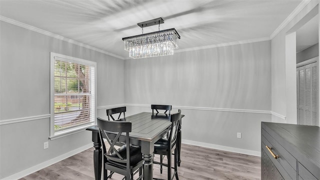 4825 Foxrun, Lakeland, FL 33813 - dining space featuring ornamental molding, a chandelier, wood finished floors, and baseboards