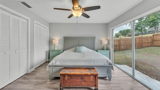 4825 Foxrun, Lakeland, FL 33813 - bedroom featuring access to outside, multiple closets, light wood-style floors, and a ceiling fan