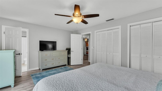 4825 Foxrun, Lakeland, FL 33813 - bedroom featuring multiple closets, wood finished floors, baseboards, a ceiling fan, and ensuite bath