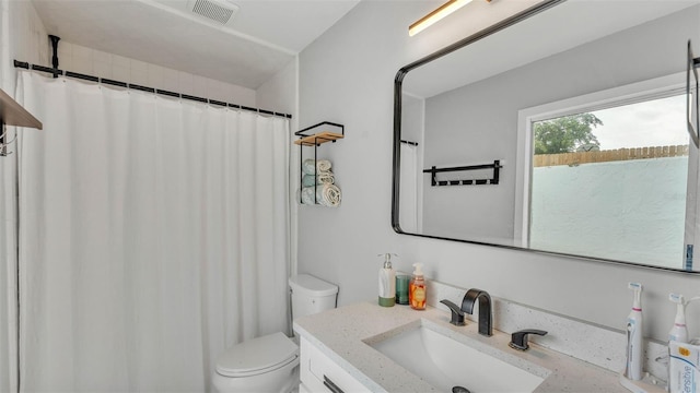 4825 Foxrun, Lakeland, FL 33813 - full bathroom with vanity, toilet, and a shower with shower curtain