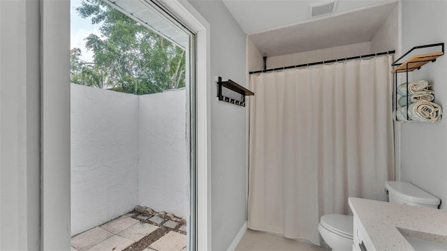 4825 Foxrun, Lakeland, FL 33813 - bathroom featuring toilet, vanity, and a shower with shower curtain