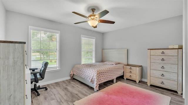 4825 Foxrun, Lakeland, FL 33813 - bedroom featuring wood finished floors, baseboards, an office area, and a ceiling fan