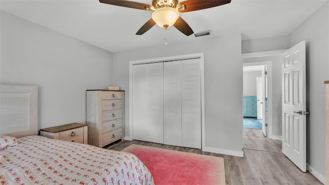 4825 Foxrun, Lakeland, FL 33813 - bedroom featuring light wood-style floors, a closet, baseboards, and ceiling fan