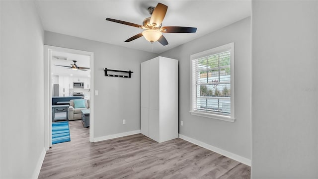 4825 Foxrun, Lakeland, FL 33813 - empty room with ceiling fan, wood finished floors, and baseboards