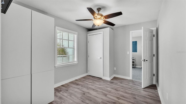 4825 Foxrun, Lakeland, FL 33813 - unfurnished bedroom featuring light wood-style flooring, baseboards, and ceiling fan