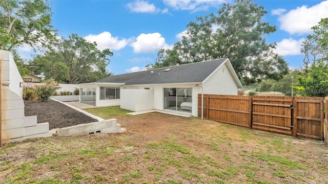 4825 Foxrun, Lakeland, FL 33813 - back of property with a sunroom and a gate