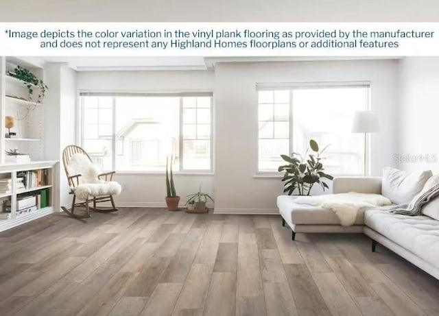 1819 Daystar Dr, Haines City, FL 33844 - living room with light wood-type flooring, healthy amount of natural light, and baseboards