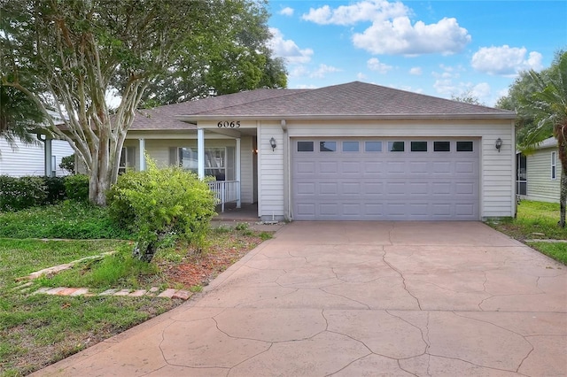 6065 Magpie Dr, Lakeland, FL 33809 - ranch-style home with driveway, an attached garage, a porch, and roof with shingles