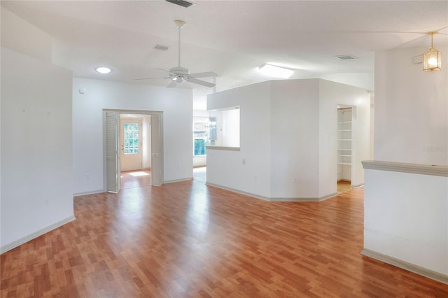 6065 Magpie Dr, Lakeland, FL 33809 - unfurnished living room with light wood-type flooring, a ceiling fan, baseboards, and lofted ceiling