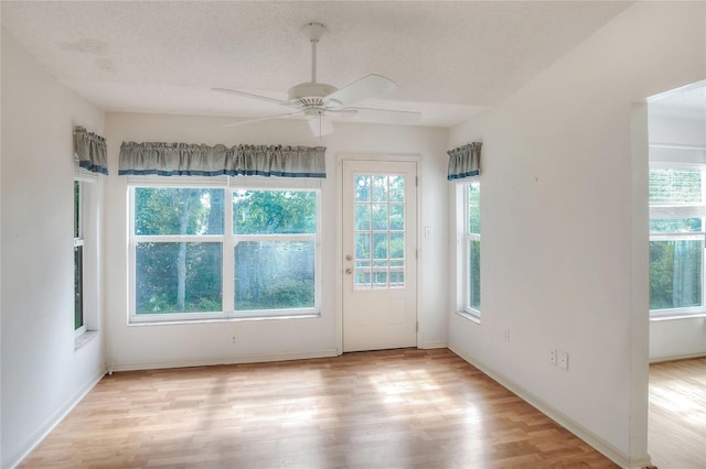 6065 Magpie Dr, Lakeland, FL 33809 - unfurnished room featuring light wood-style flooring, ceiling fan, a textured ceiling, and baseboards