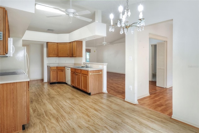 6065 Magpie Dr, Lakeland, FL 33809 - kitchen with a ceiling fan, a sink, a peninsula, white appliances, and light wood-type flooring