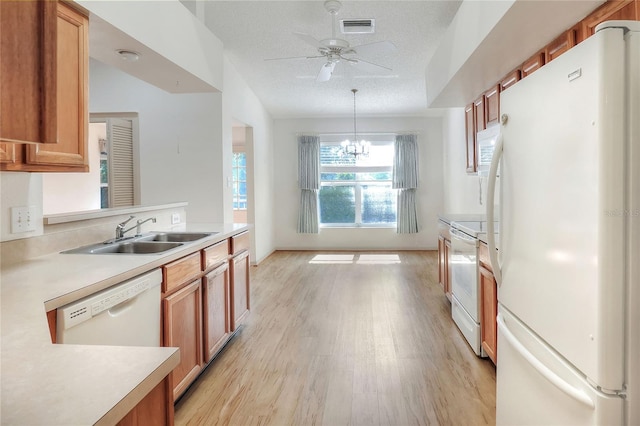 6065 Magpie Dr, Lakeland, FL 33809 - kitchen with white appliances, a sink, light wood-style floors, light countertops, and a ceiling fan