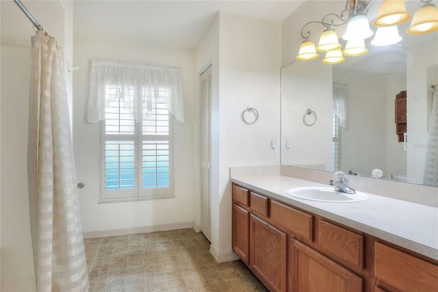 6065 Magpie Dr, Lakeland, FL 33809 - full bath featuring a chandelier, vanity, baseboards, and curtained shower