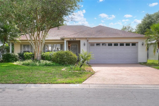6065 Magpie Dr, Lakeland, FL 33809 - ranch-style house with a front yard, a garage, and concrete driveway