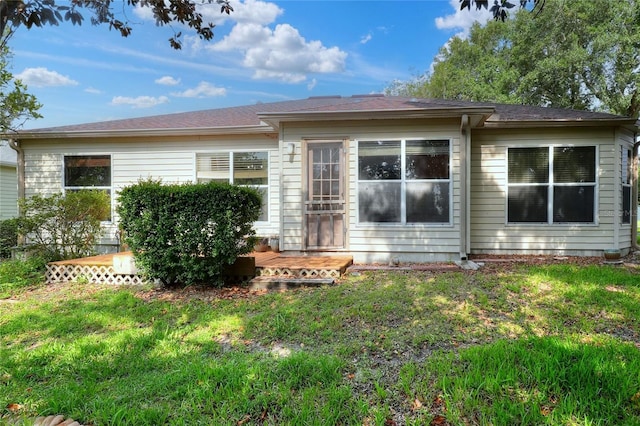6065 Magpie Dr, Lakeland, FL 33809 - rear view of property with a lawn