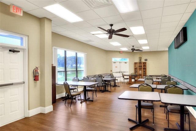 6065 Magpie Dr, Lakeland, FL 33809 - dining room featuring a ceiling fan, wood finished floors, a paneled ceiling, and baseboards