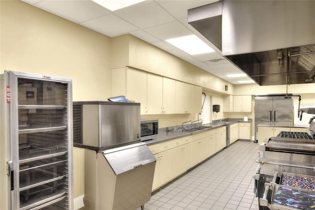 6065 Magpie Dr, Lakeland, FL 33809 - kitchen featuring wine cooler, a sink, appliances with stainless steel finishes, cream cabinets, and light tile patterned floors